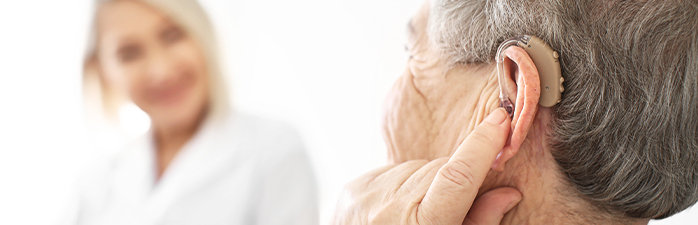 Woman touching her hearing aid